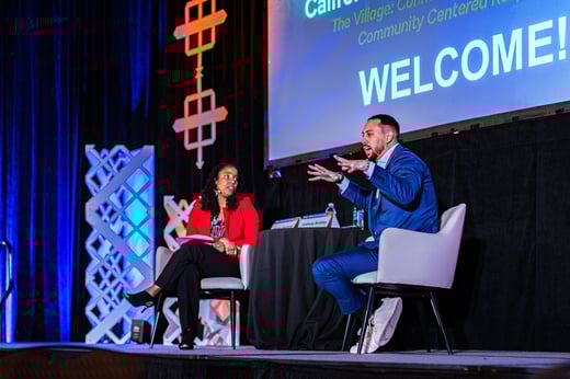 Woman and man sitting and talking on a stage